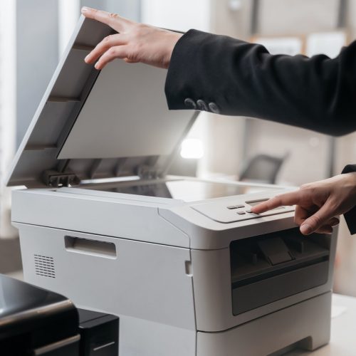 Business woman is using the printer to scanning and printing document